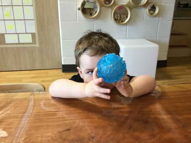 toddler observing a ball
